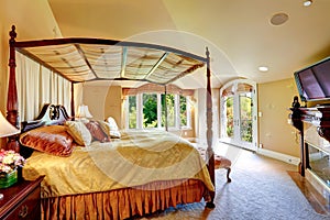 Luxury house interior. Beautiful bed with high posts