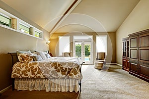 Luxury house interior. Bedroom with high vaulted ceiling and walkout deck photo