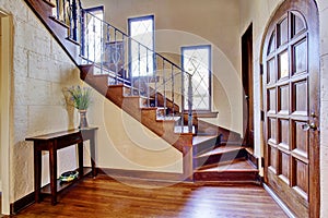 Luxury house interior. Entrance hallway with staircase photo