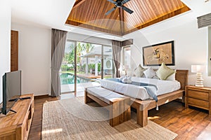 Luxury Interior design in bedroom of pool villa with cozy bed with high raised ceiling in the house or home building