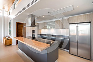 Luxury interior design pool villa in kitchen area which feature island counter and built in furniture in the house or home