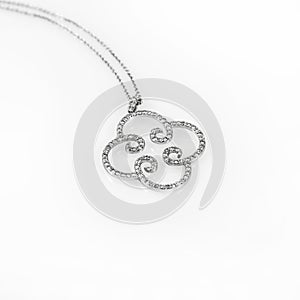 Luxury jewellery. White gold or silver pendant isolated on white background. Selective focus.