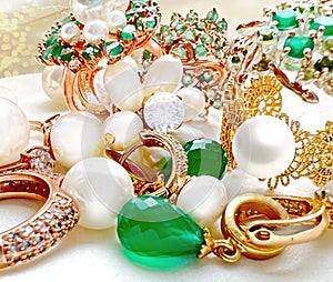 Luxury jewelry Emerald greeen white pearl gold rings and earing jewelry on white background