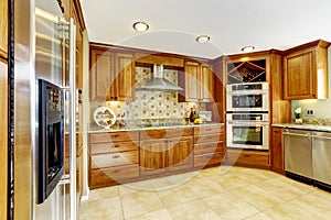 Luxury kitchen with tile floor and stained cabinets