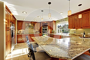 Luxury kitchen with tile floor and stained cabinets