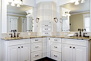 Luxury large white master bathroom cabinets with double sinks.