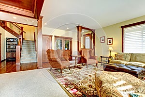 Luxury living room with chery wood and staircase.