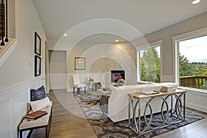 Luxury living room features corner stone fireplace