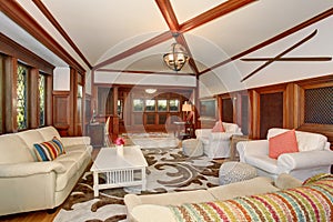 Luxury Living room interior with brown wooden trimmings and vaulted ceiling with beams