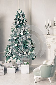 Luxury living room interior with sofa decorated chic Christmas tree, gifts, plaid and pillows.happy new year, decorated