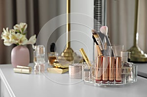 Luxury makeup products and accessories on dressing table with mirror