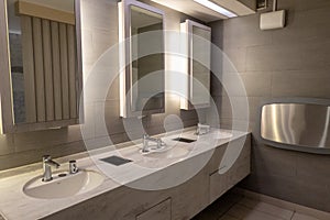 Luxury marble basin with light in mirror in public toilet