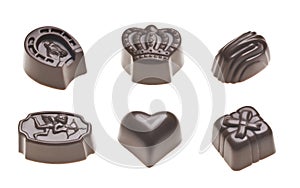 Luxury milk chocolate truffles. Assorted delicious handmade pralines in a row isolated on white.