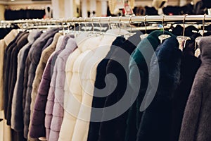 Luxury mink coats. Grey, brown, pearl color fur coats on showcase of market. Best gift for women is mink coat. Outerwear