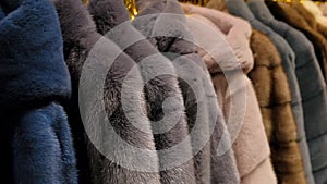 Luxury mink fur winter coat for winter sale on a clothes rack in a retail fashion store. Close up.
