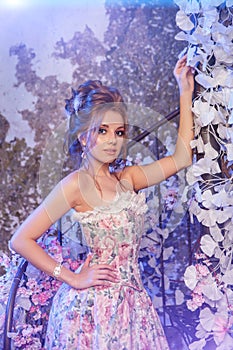 Luxury model in vintage style. Beautiful woman with a stunning hairstyle and make-up in a rococo dress. Girl at the Masquerade