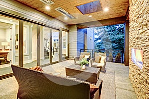 Luxury deck modern exterior with stone fireplace and wooden ceiling