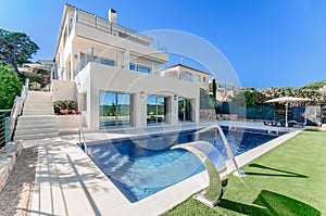 Luxury modern house with swimming pool with waterfall jet. House