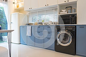 Modern kitchen interior with washing machine.