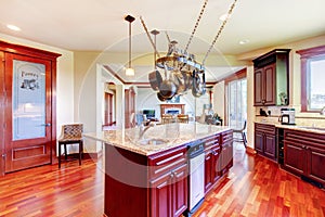 Luxury modern kitchen room with mahogany storage combination .