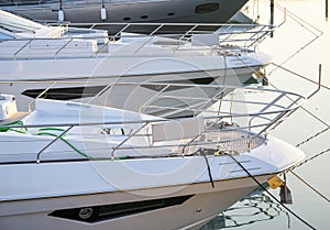 Luxury motor yacht docked in port at sunset