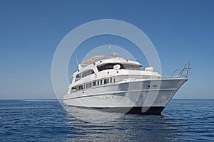 Luxury motor yacht sailing out on tropcial sea