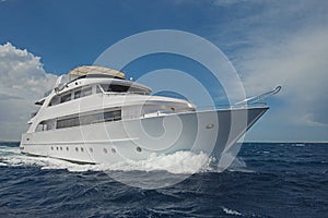 Luxury motor yacht sailing out on tropcial sea