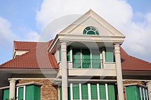 A luxury multi storey house against an azure blue sky backdrop