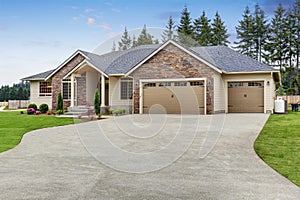Luxury one level house exterior with brick trim and garage