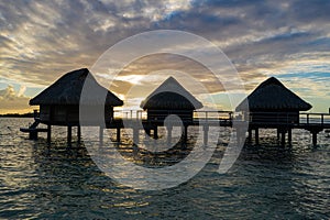 Luxury overwater villas during sunrise and Otemanu mountain at Bora Bora island, Tahiti
