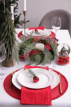 Luxury place setting with beautiful festive decor for Christmas dinner on white table