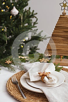 Luxury place setting with beautiful festive decor for Christmas dinner on white table