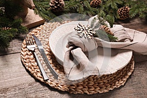 Luxury place setting with beautiful festive decor for Christmas dinner on wooden table, closeup