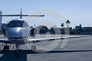 Luxury private jet is parked on an airfield at dusk