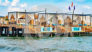 Luxury private lodges, sun beds and mini pools on a wooden dock in Antalya