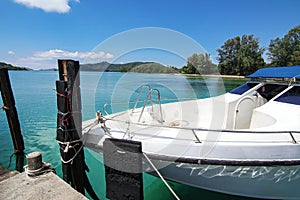 Luxury private speedboat yacht service at travel island beach pier and transparent clear sea water with cloud blue sky background