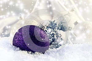 Luxury purple Christmas ball with ornaments in Christmas Snowy Landscape.