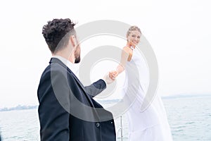 Luxury relaxing couple in nice dress and suite hold hand background white sky. Concept business travel