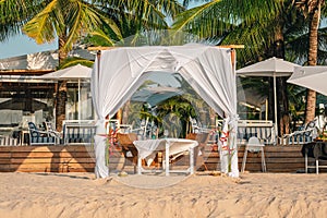 Luxury resort hotel outdoor restaurant on the beach, tropical island cafe, table ready for serving. Summer vacation or holiday,
