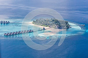 Luxury resort island in Maldives with water bungalow background and blue sea sky aerial view