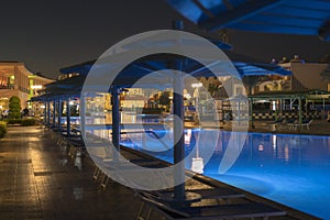 luxury resort with pool at night view. hotel outdoor landscape with pool. Night pool side of rich hotel