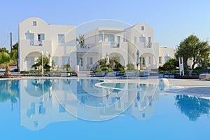 Luxury resort white villas over blue pool water