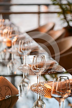 Luxury restaurant table decorations. Glasses and plates are set up on this beautiful table