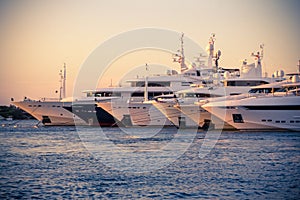 Luxury, rich Yachts moored in a harbor of Porto Cervo photo