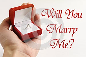 Luxury ring in hand, will you marry me text, greeting card conce
