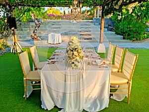 A luxury and romantic dining table set up in the green garden