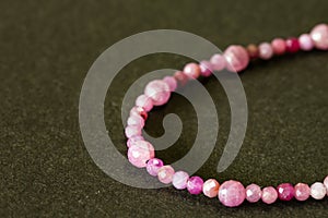 Luxury ruby necklace or bracelet on black background.