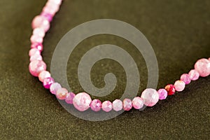 Luxury ruby necklace or bracelet on black background.