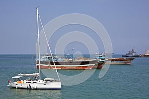 Luxury sailing boat, fishing and cargo ships at anchor in the port of Djibouti