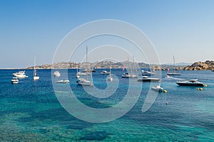 Luxury sailing and motor yachts at scenic Porto Massimo bay
